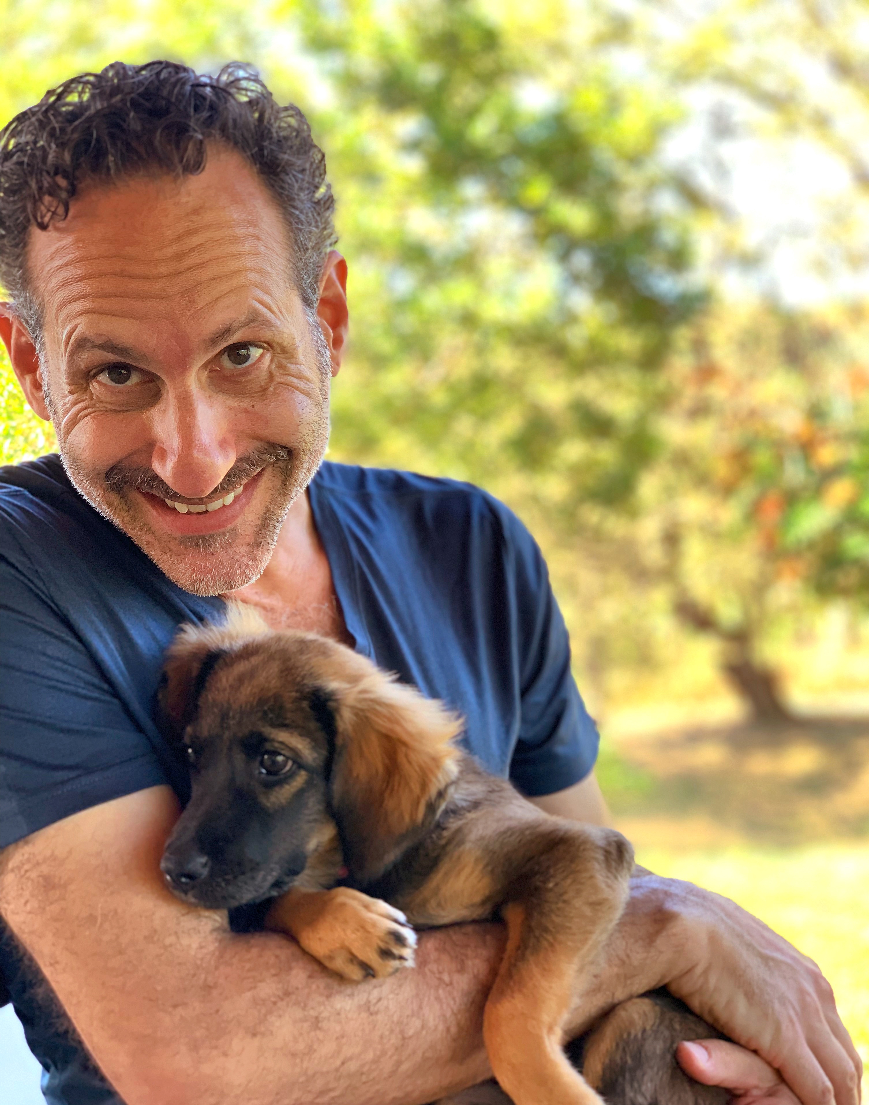 Steven with a tiny puppy, outdoor portrait