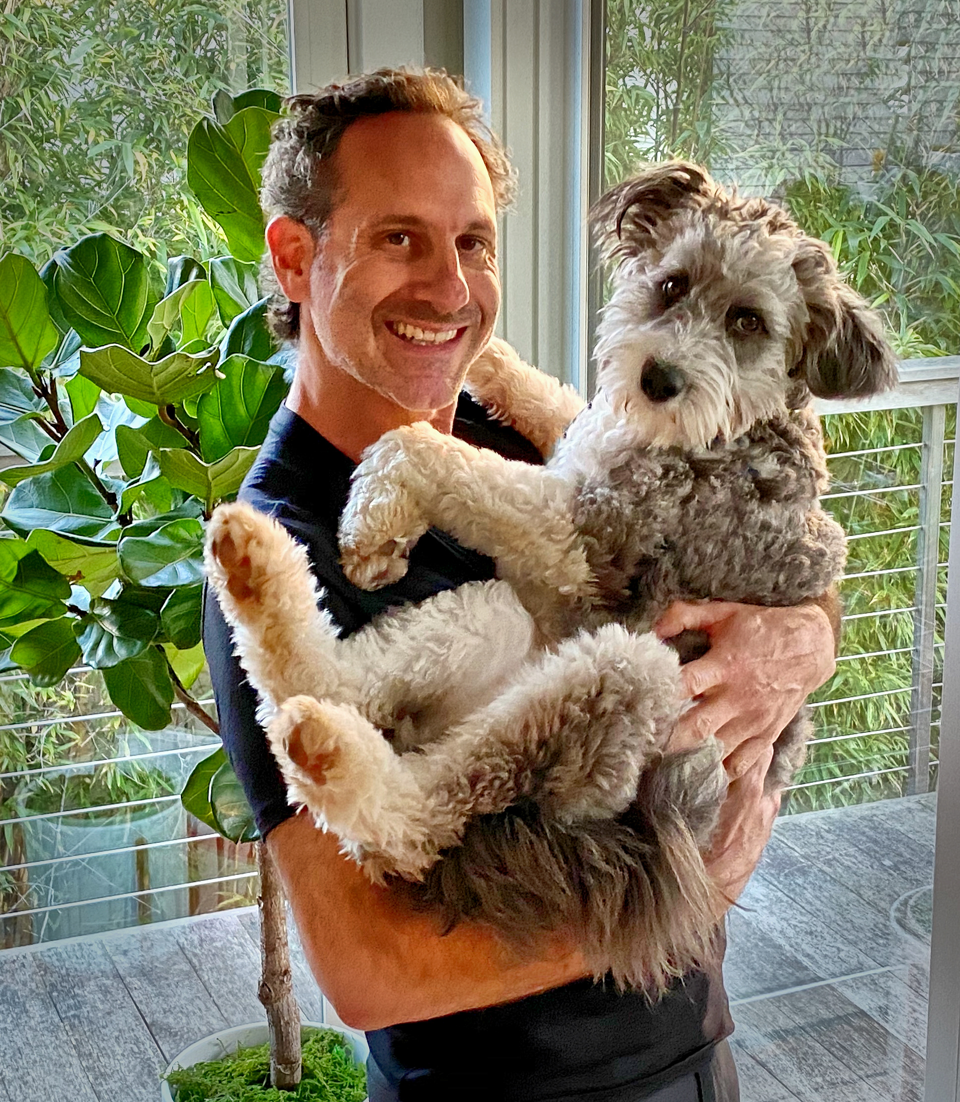 Steven holding a fluffy doodle